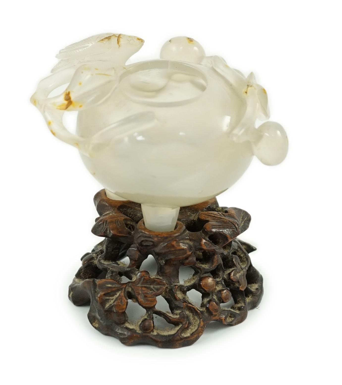 A Chinese small carved agate brushwasher on wooden stand, 19th century, 8.5cm high including stand